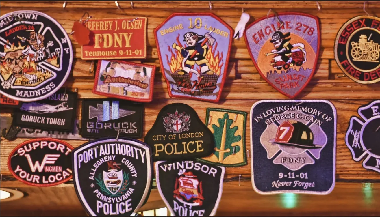 Close-up of first responder patches covering the pub wall